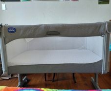 Next to me Chicco magic cot with snuz breatheble matress and bed sheets.