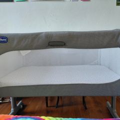 Next to me Chicco magic cot with snuz breatheble matress and bed sheets.