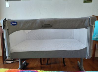 Next to me Chicco magic cot with snuz breatheble matress and bed sheets.
