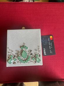 embellished bag with green stones