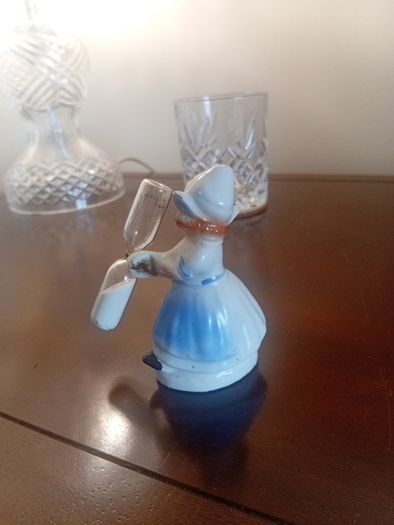 vintage porcelain egg timer featuring a dutch girl in traditional dress