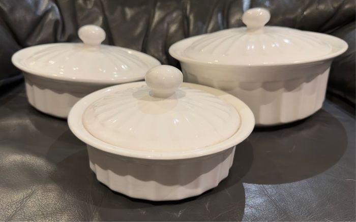 3 white serving bowls with lids.