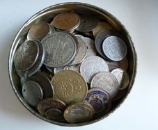 Old tobacco tin full of coins