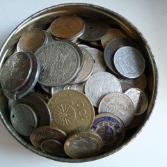 Old tobacco tin full of coins