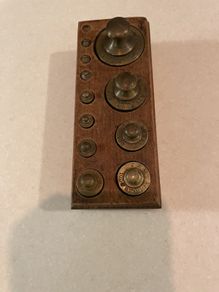 Antique brass weights in original wooden stands