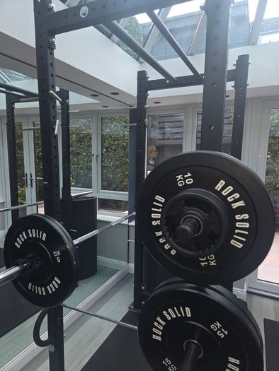 Mint condition - amazing heavy duty black squat rack with almost brand new Rock Solid barbell and bumper plates - a must see!!!