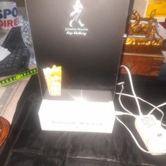 A Johnnie Walker flashing light bar display sign, with etched Striding Man logo and Keep Walking slogan