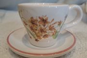 Miniature vintage teacup and saucer with candle