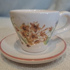 Miniature vintage teacup and saucer with candle