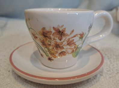 Miniature vintage teacup and saucer with candle