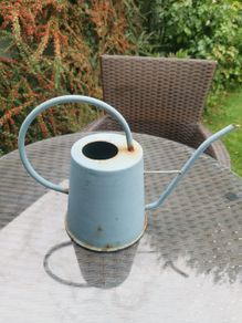 Watering can light blue. Metallic.