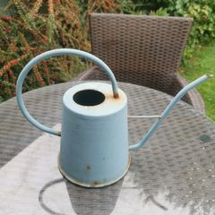 Watering can light blue. Metallic.