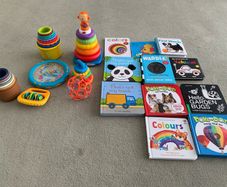 Baby toys, stacking rings and boxes and a selection of books