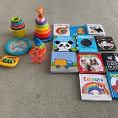 Baby toys, stacking rings and boxes and a selection of books