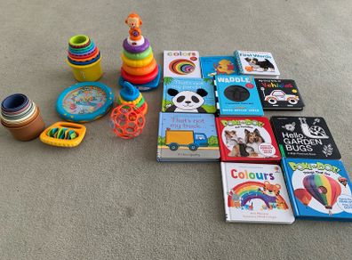 Baby toys, stacking rings and boxes and a selection of books
