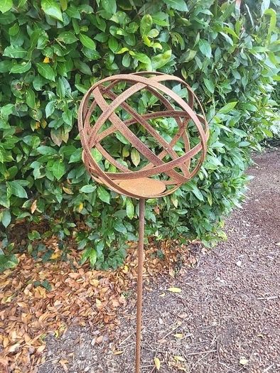 Corten steel garden sphere on a stem