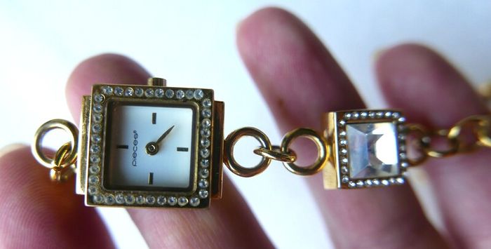 Pieces gold tone bracelet watch with crystal detail