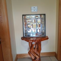 Faceted and Bevelled Bronze Framed Arts and Crafts Style Mirror.
