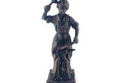 Vintage metal figurine of a blacksmith