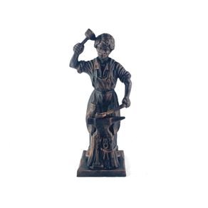Vintage metal figurine of a blacksmith