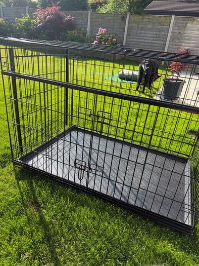 XL dog crate opens up by sliding doors at front and side. Read caption