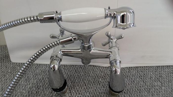 Retro bath mixer with handheld shower head.