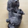 The figurine is a bears sculpture, manufactured by Wolf Originals in Canada. Image 5