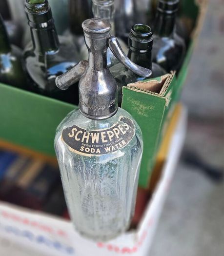 Box of Vintage Bottles and Schweppes Soda Syphon