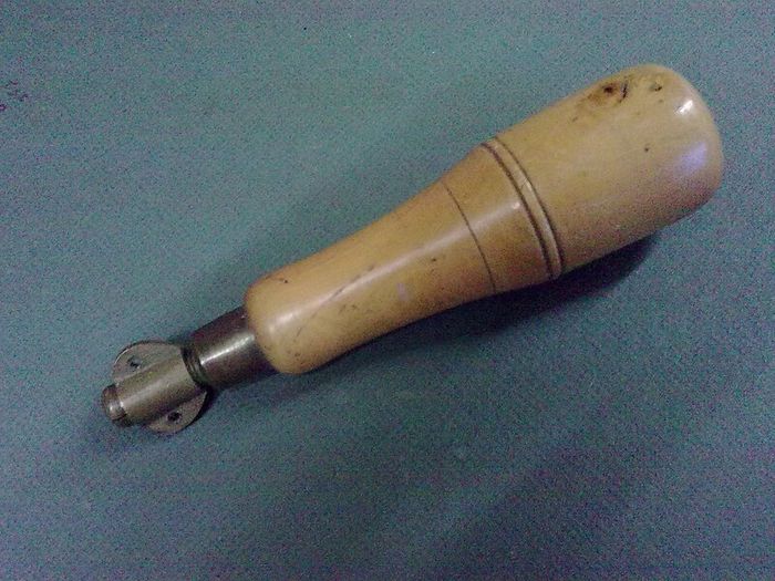 Old boxwood and brass tool pad with tools