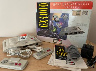 Boxed Amstrad GX4000 console with 2 controllers, cables, inserts, and pack-in game