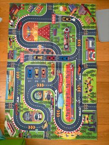 three toy cars playing mats