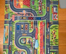 three toy cars playing mats