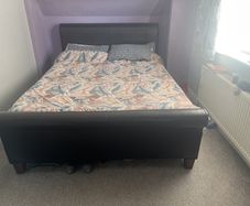king size bed with black leather head board