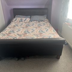 king size bed with black leather head board