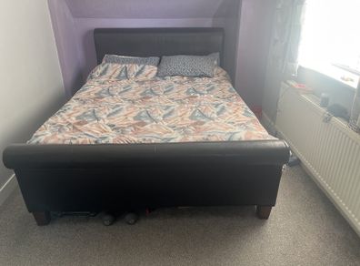 king size bed with black leather head board