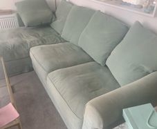 Corner sofa incorporating guest single bed and storage