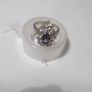 a silver dress ring with 10 white stones and purple stone Image 5