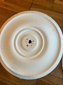 Pair of decorative white ceiling roses for chandeliers or pendant lights.