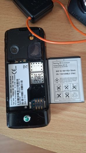 Sony Ericsson W200i , with charger and speakers.