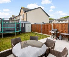Garden trampoline with safety enclosure