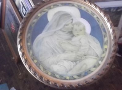 a antique holy picture in round frame