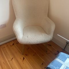 armchair in boucle fabric with wooden legs