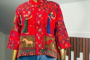 A gorgeous, rich tapestry/boho style with floral embroidery details, animal motifs with a structured mandarin/mock collar, and relaxed wide sleeves