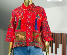 A gorgeous, rich tapestry/boho style with floral embroidery details, animal motifs with a structured mandarin/mock collar, and relaxed wide sleeves