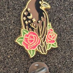 Raven and rose ,  pin back badge.