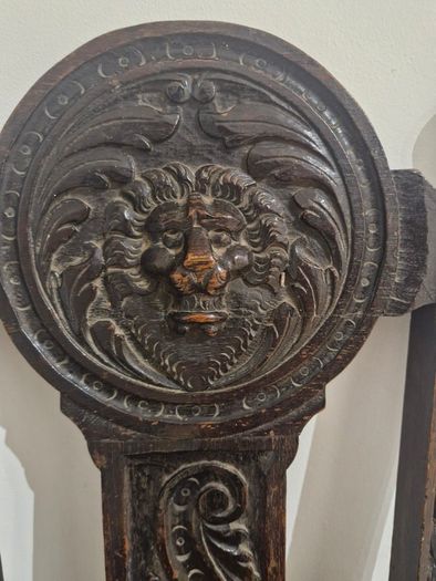 Carved oak antique chair with lion face motif