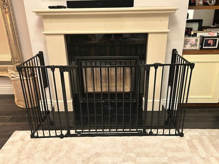 Black metal fire guard and safety gate