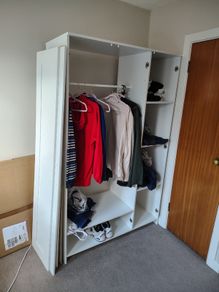 White wardrobe with hanging rail and shelving