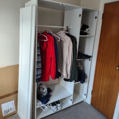 White wardrobe with hanging rail and shelving