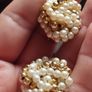 Vintage clip-on earrings with a cluster of faux pearls and gold-tone beads. Image 6